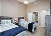 3rd Bedroom showcases 2 Twin Beds with Beach Blue Hues and TV.