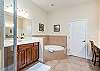Master Bathroom features double vanities, shower and separate soaking tub. 
