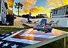 The yard by the pool is a great area to play cornhole.