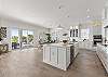 Open Concept Kitchen, Dining and Living Room on the ground floor with Glass Doors leading out to the Patio.