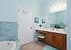 Master bathroom features soaking tub and separate shower and dual vanities. 