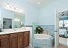Master Ensuite features soaking tub and separate shower and dual vanities. 
