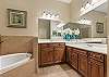 Primary Ensuite with soaking tub, separate shower and dual vanities. 