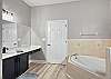 Primary Ensuite with soaking tub and separate shower. 