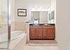 Master ensuite features double vanities, shower and separate tub.