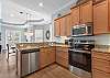Kitchen features stainless steel appliances. 