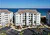 Oceanfront Condo Building with a Beach Walkover to the Left of the Building. 