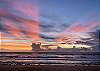 Take a walk on the beach as the sun rises over the ocean. 