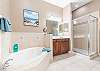 Master Bathroom Features shower, separate soaking tub and double vanities. 