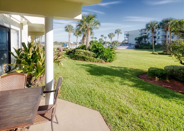 Patio features a table with seating for four and an electric grill for outdoor barbequing. Perfect spot to relax and unwind! 