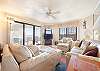 Spacious living room with open floor plan and connected balcony featuring a direct view of the ocean.
