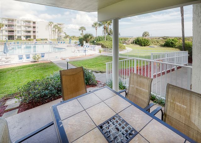Patio features a table with seating for six and an electric grill for outdoor barbequing. Perfect spot to relax, unwind and keep an eye on the children in the pool!