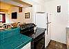 The kitchen has full-size appliances, a dbl sink, and brand new flat-top stove.