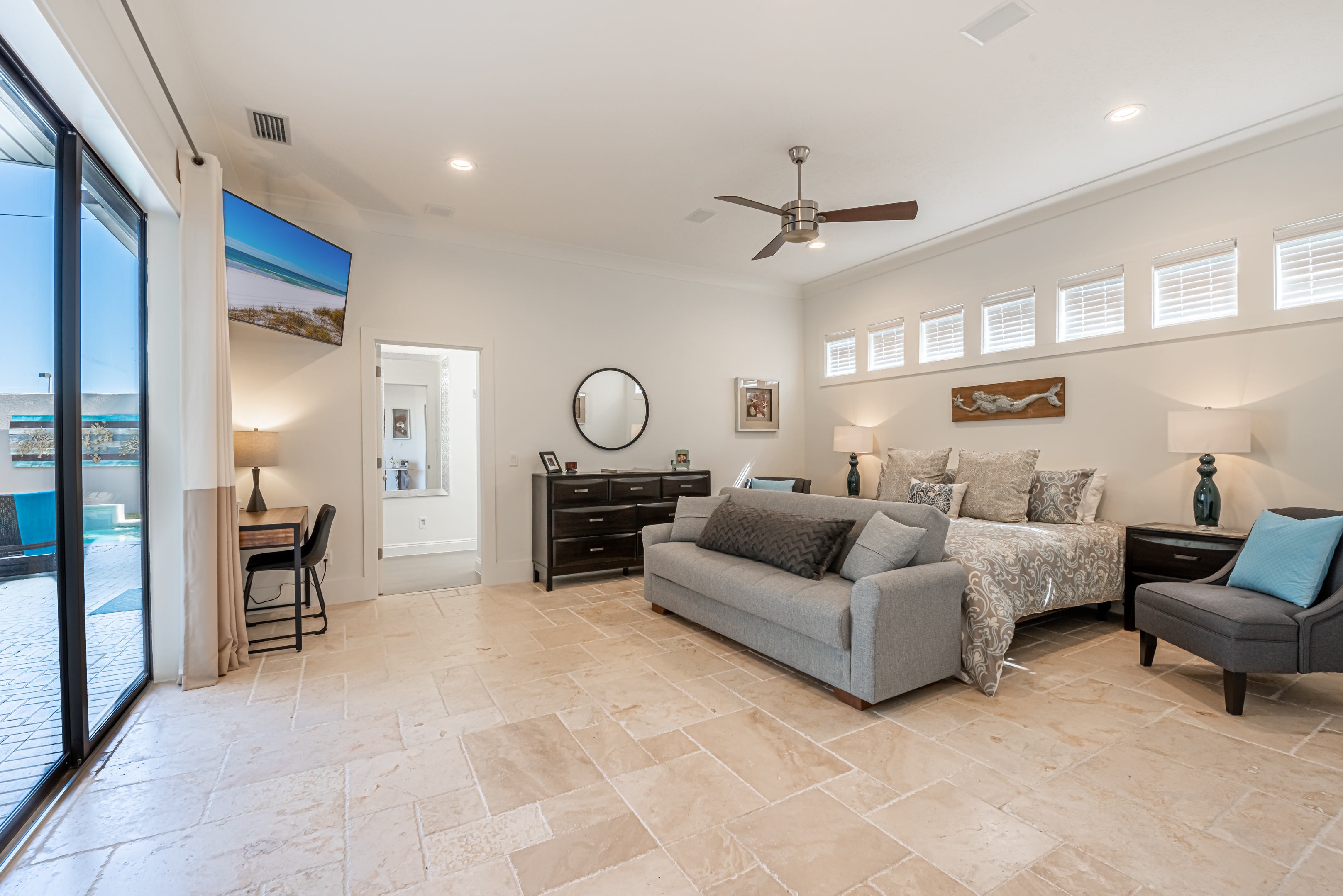 Spacious primary bedroom with door to backyard