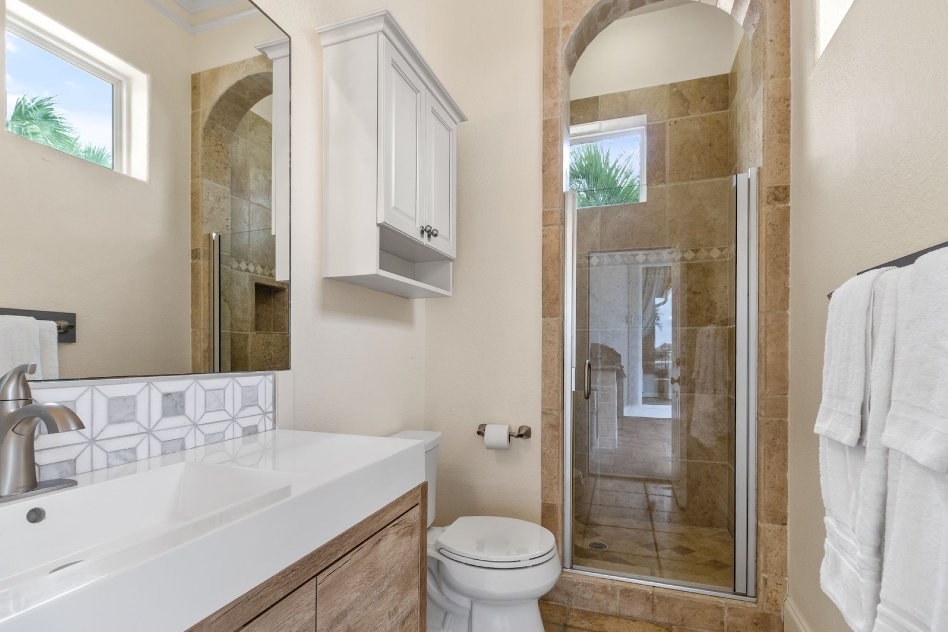 Full outdoor bathroom in pool area with walk-in shower