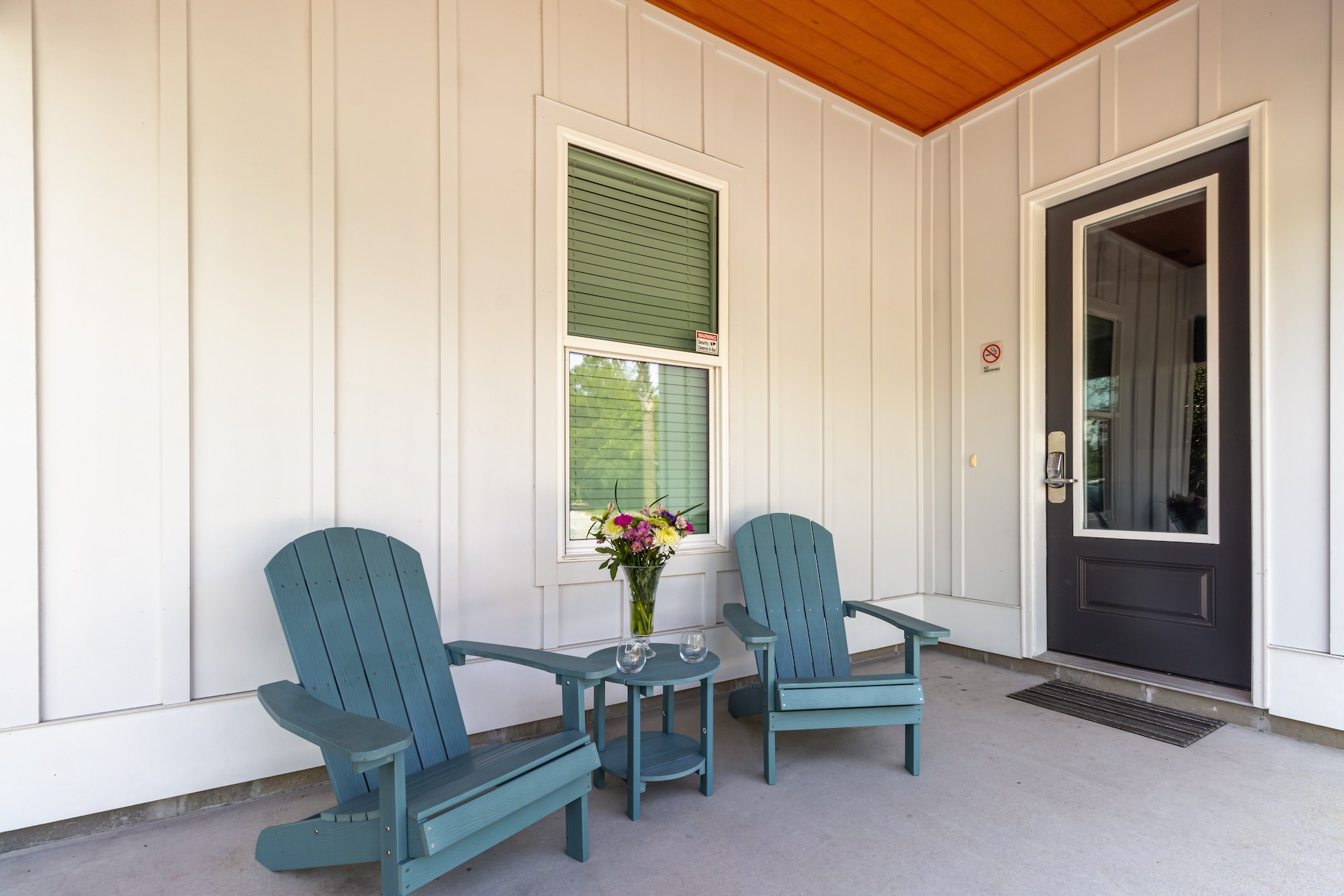 House entrance with patio seating
