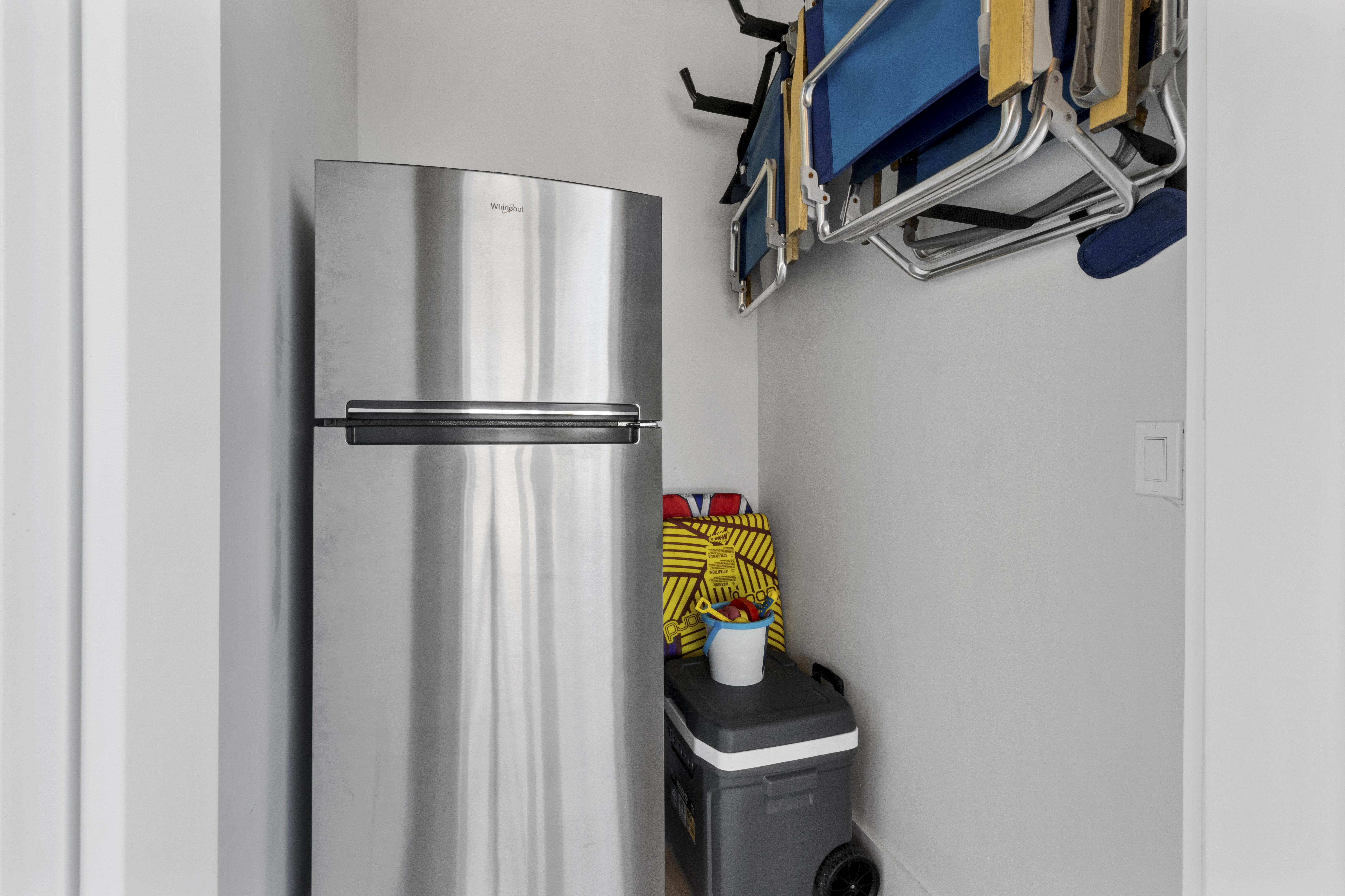 Storage room with extra refrigerator and beach gear