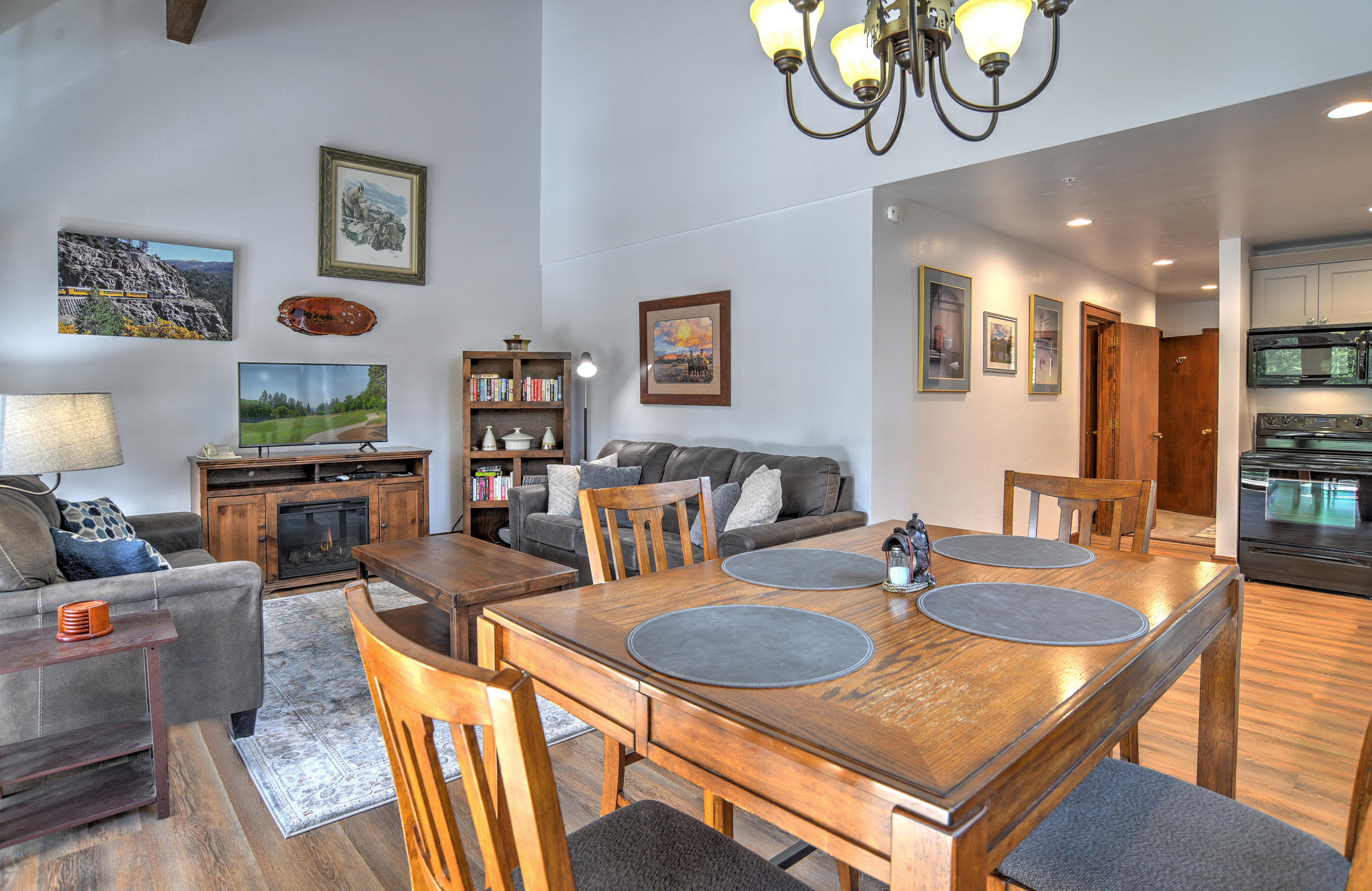 Open concept living room, dining room, and kitchen area, with plenty of natural light. 