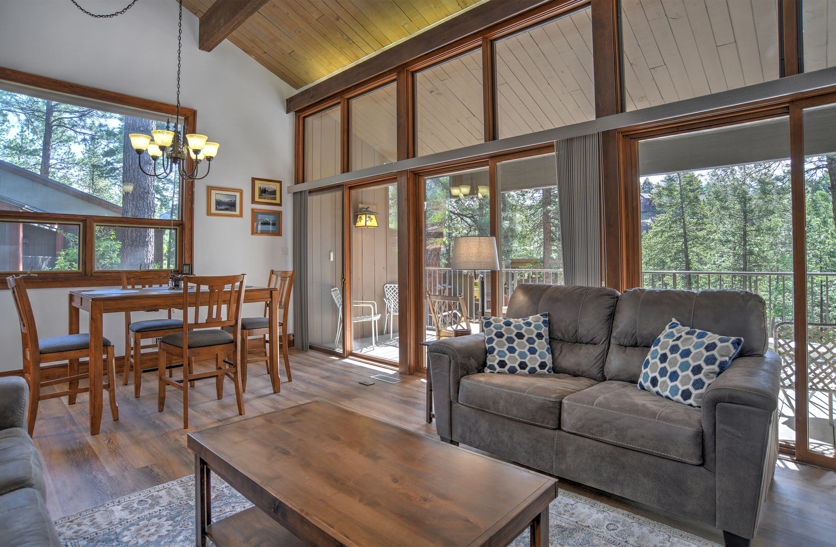Open concept living room, dining room, and kitchen area, with plenty of natural light. 