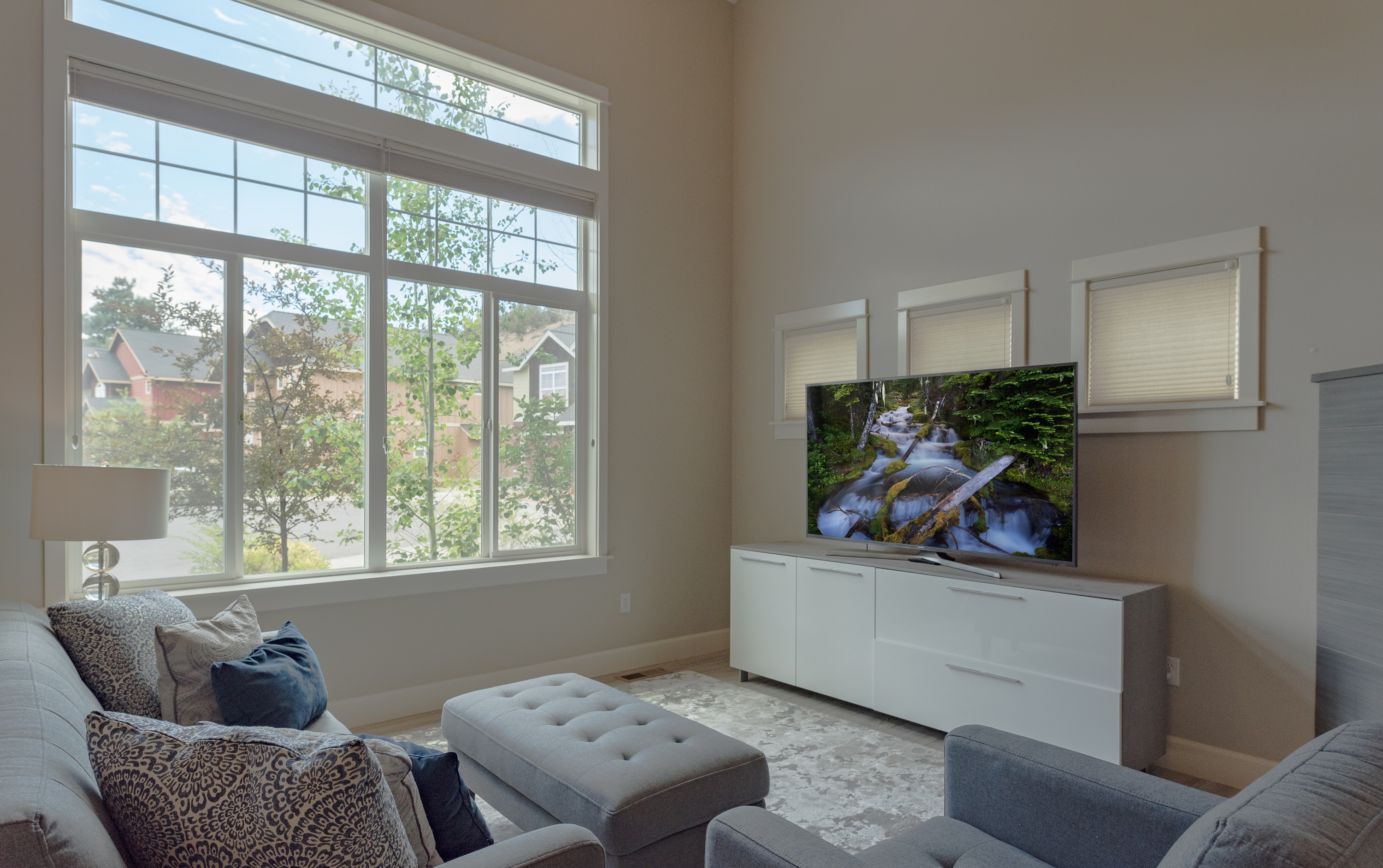 Living room with large smart TV and gas fireplace. 