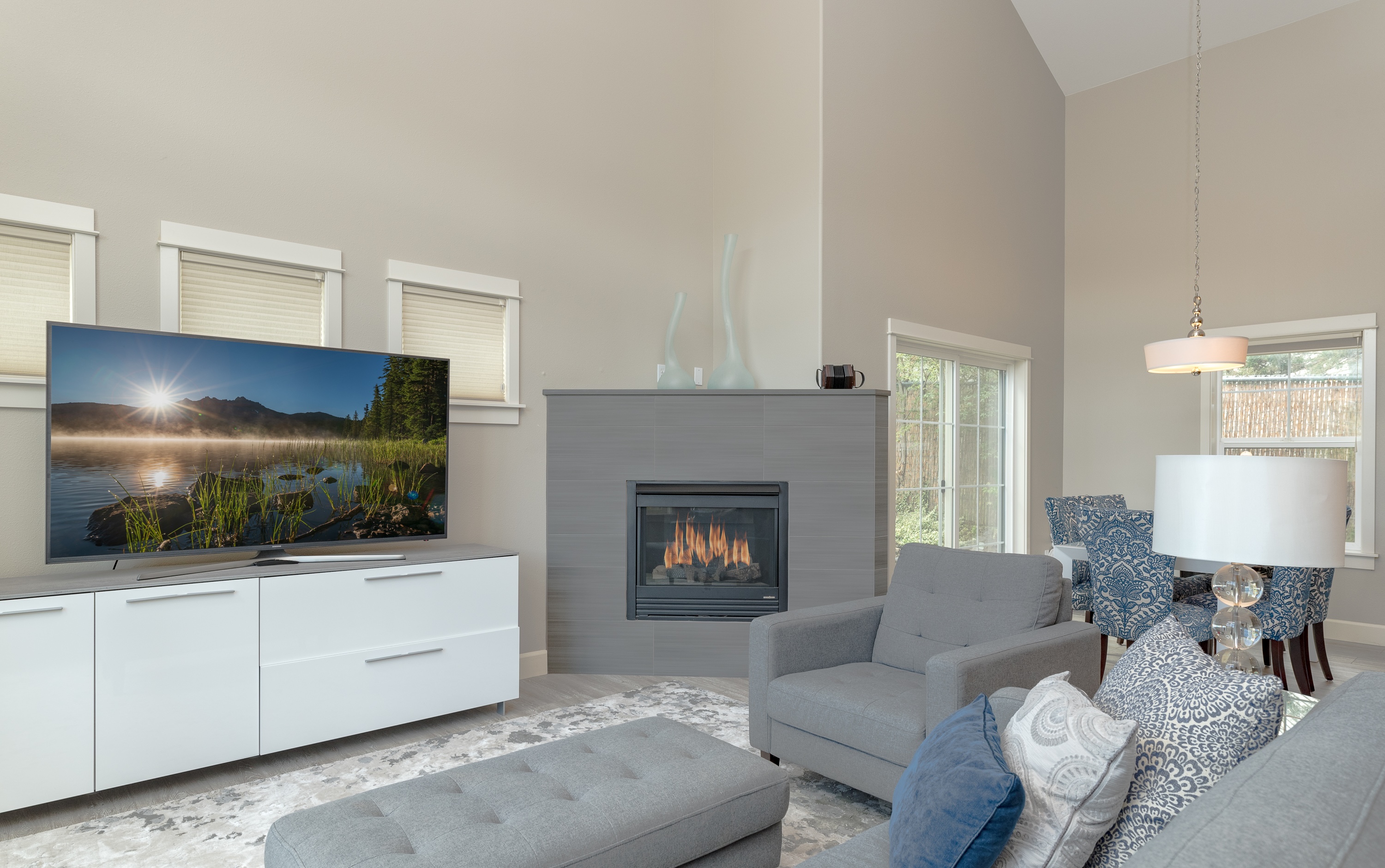 Living room with large smart TV and gas fireplace. 