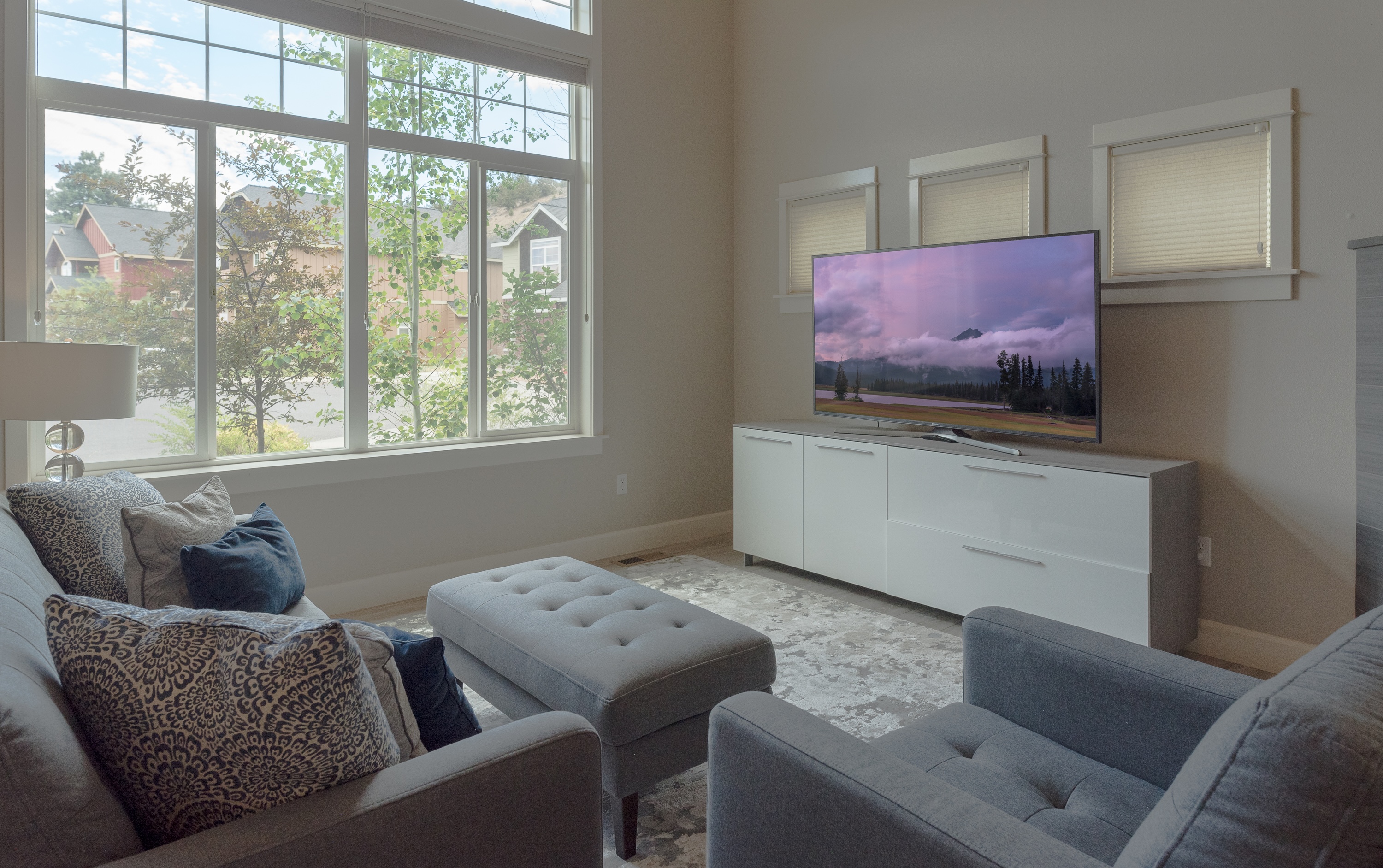 Living room with large smart TV and gas fireplace. 