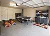 A full size garage with ping pong table and corn hole games as well as a bike pump and work bench