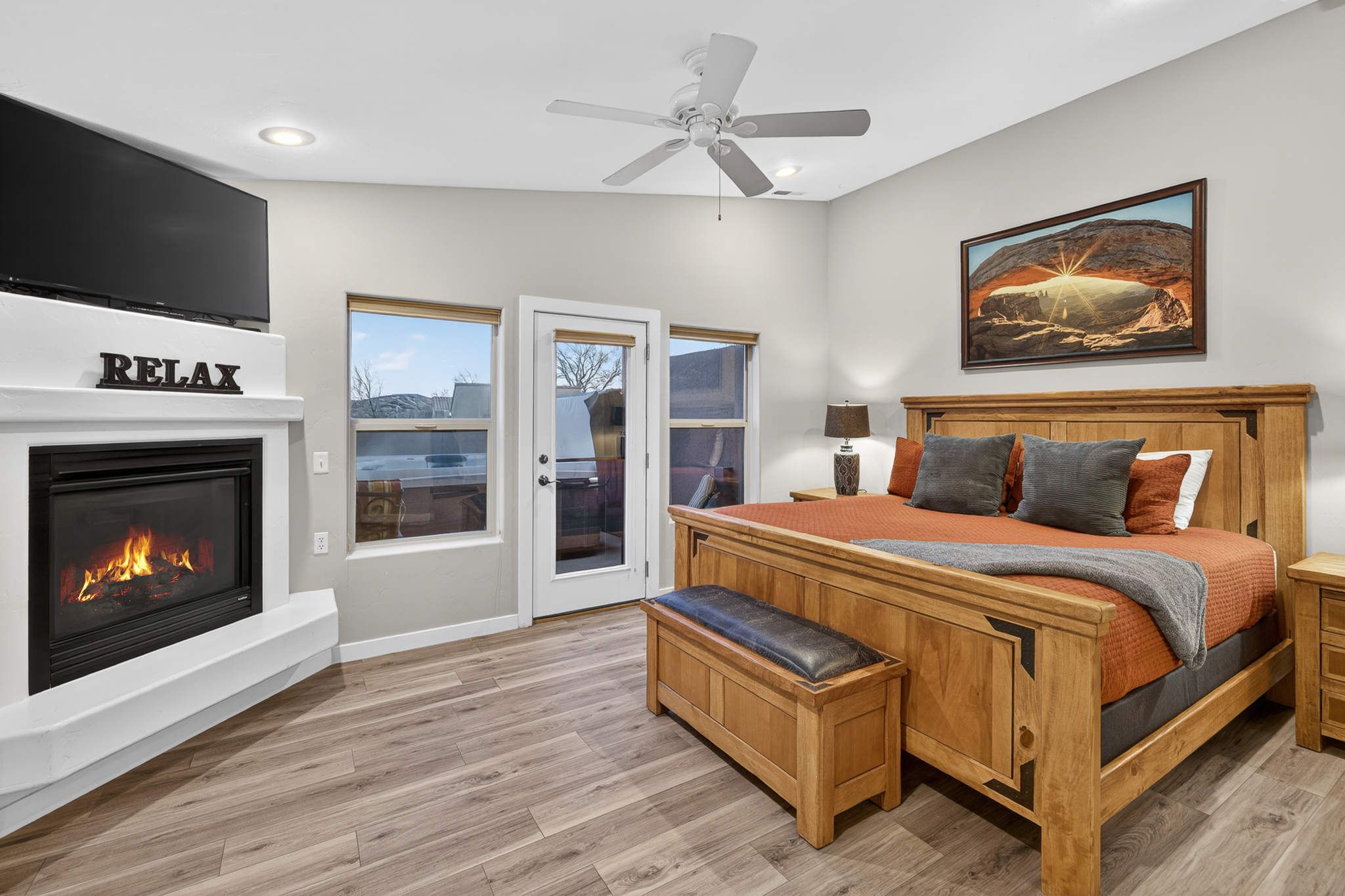 Master bedroom with fireplace, king bed and attached bath