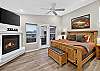 Master bedroom with fireplace, king bed and attached bath