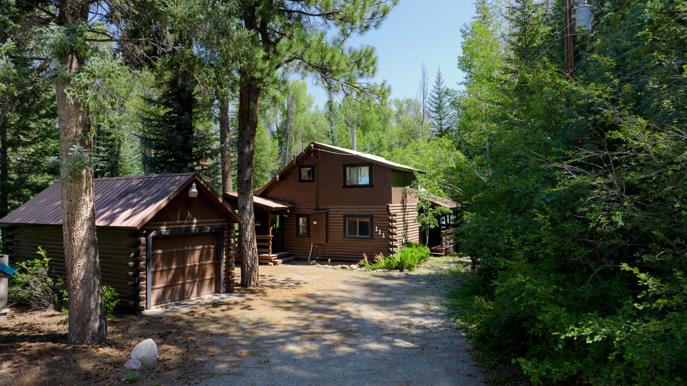 The residential street dead ends at the cabin