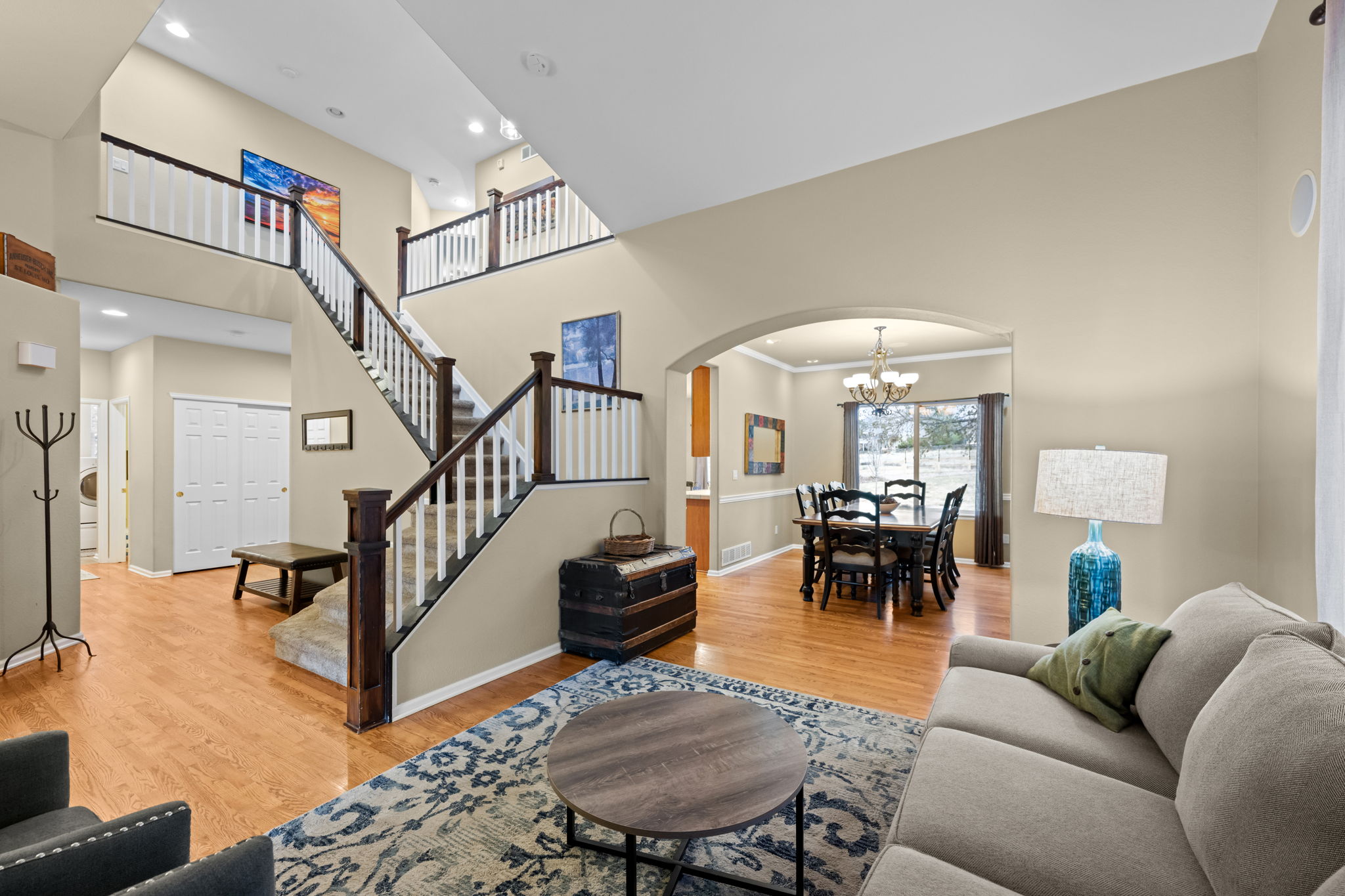 Formal living room through dining and stairwell