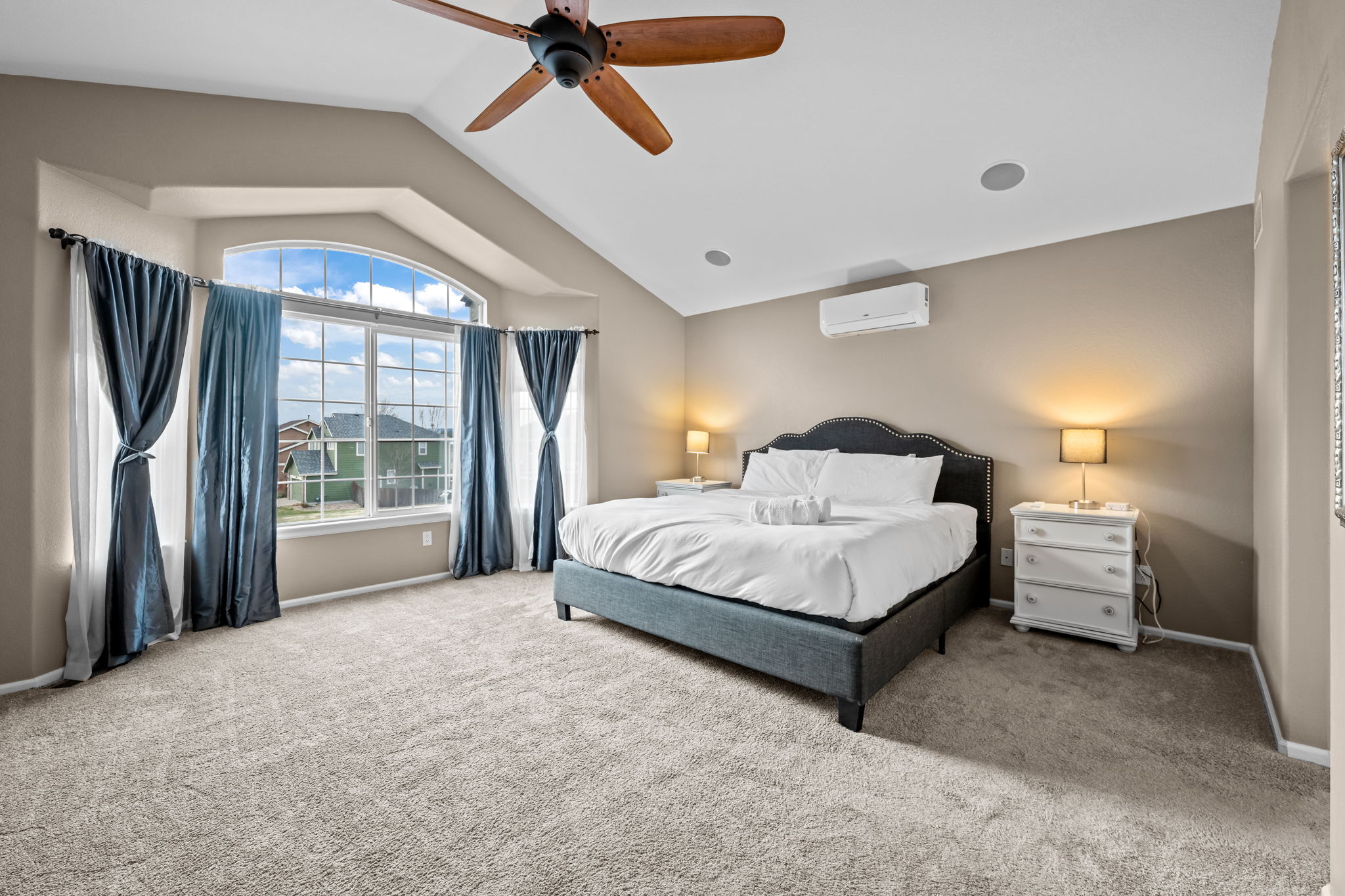 Primary bedroom, king bed, TV, mini-split, elliptical, hand weights