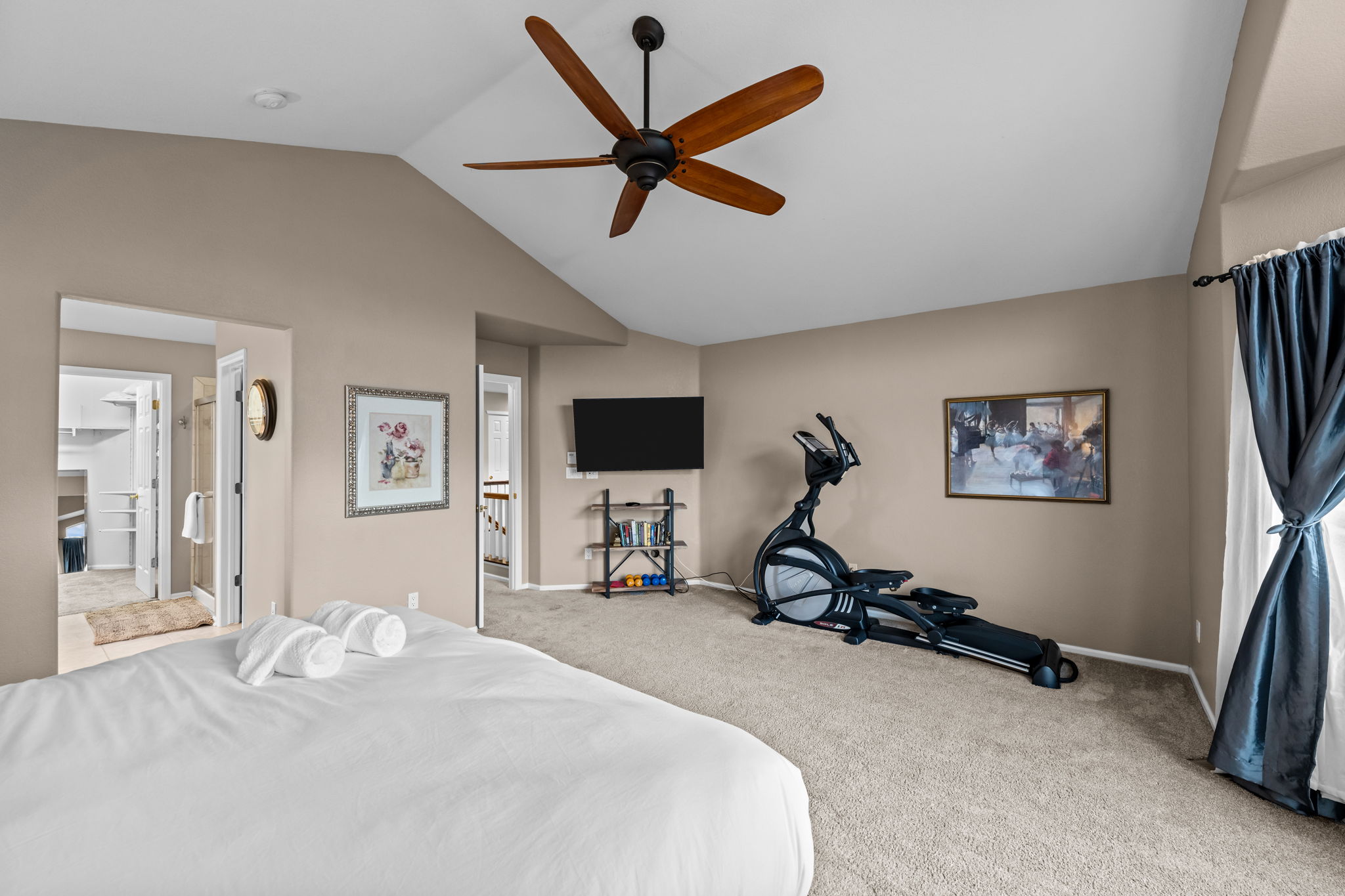 Primary bedroom, king bed, TV, mini-split, elliptical, hand weights