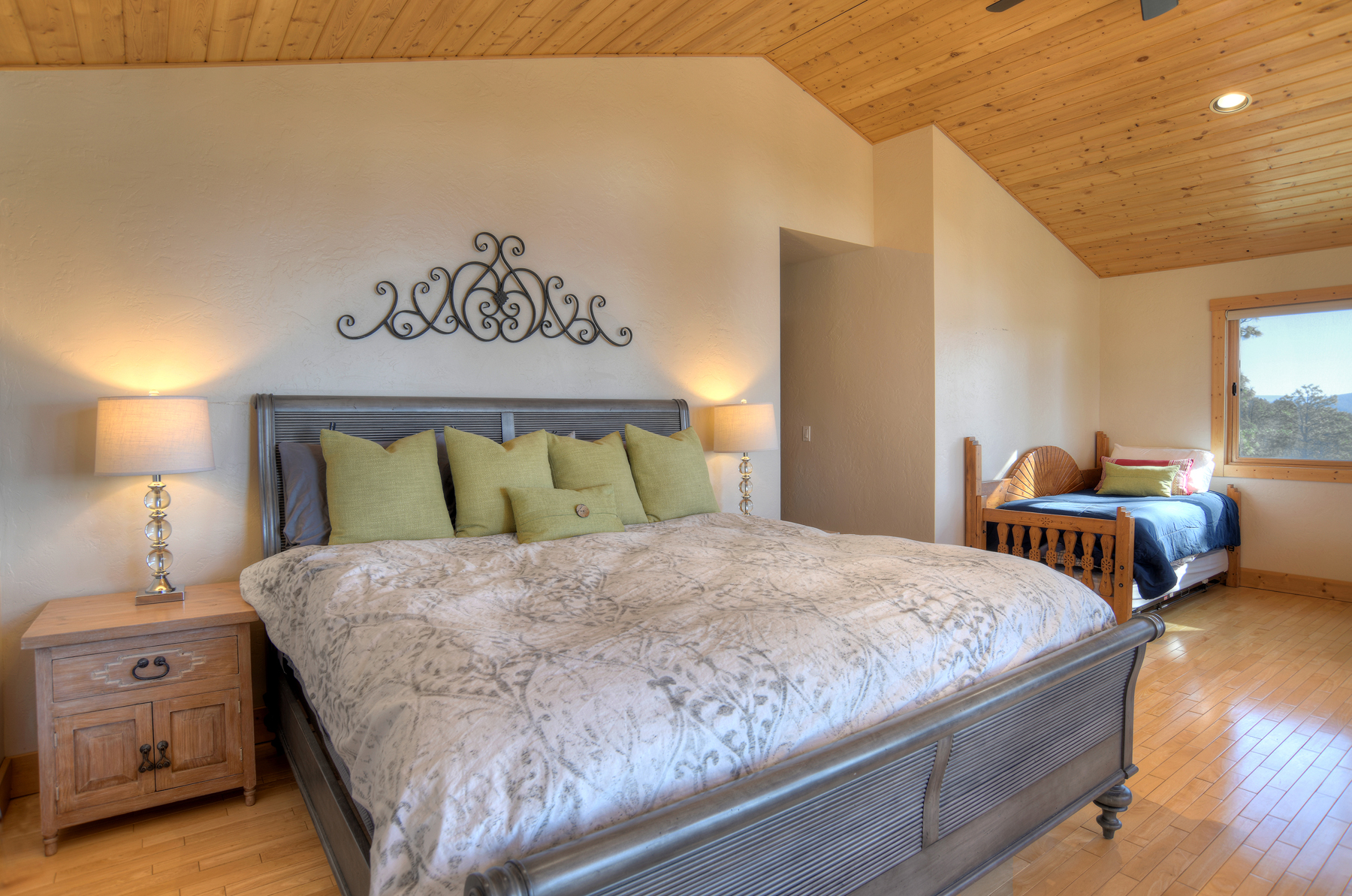 Master bedroom with king bed, ceiling fan, gas fireplace, TV and deck.
