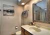 Full bathroom with convenient tub/shower combo and modern finishes.