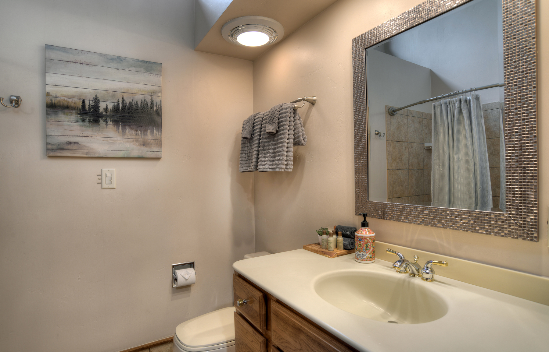 Full bathroom with convenient tub/shower combo and modern finishes.