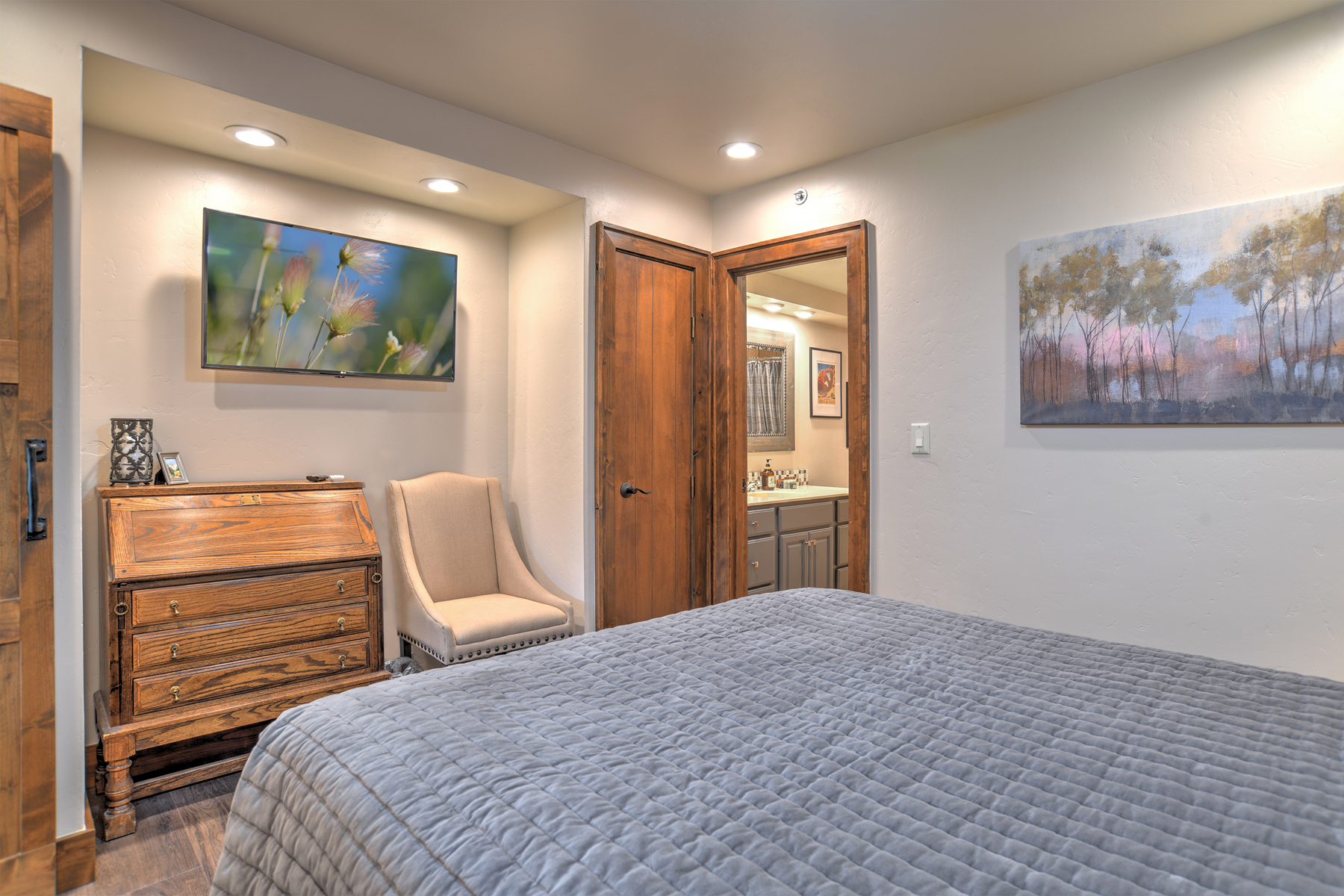 Relax and recharge in this cozy queen bedroom retreat on the main level