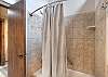 Full bathroom with convenient tub/shower combo and modern finishes.
