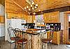Kitchen with bar seating open to living room and dining area.