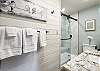 Second-floor bathroom featuring a walk-in shower and granite countertops