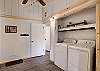 Laundry room with bench seat for taking off boots and access to the garage.