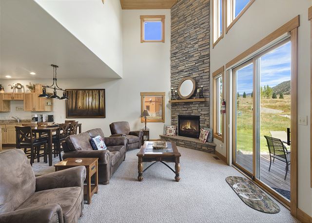 Main living space with electric fireplace overlooking the 9th green.