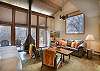 Living Room with Vaulted Ceilings, Fireplace, and TV