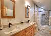 One of two shared hall bathrooms with dual vanity and shower/tub combination on the second floor.  