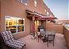 Large back patio with seating and grill