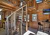 Living room with spiral staircase to loft bedroom. 