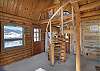 Living room with spiral staircase to loft bedroom. 