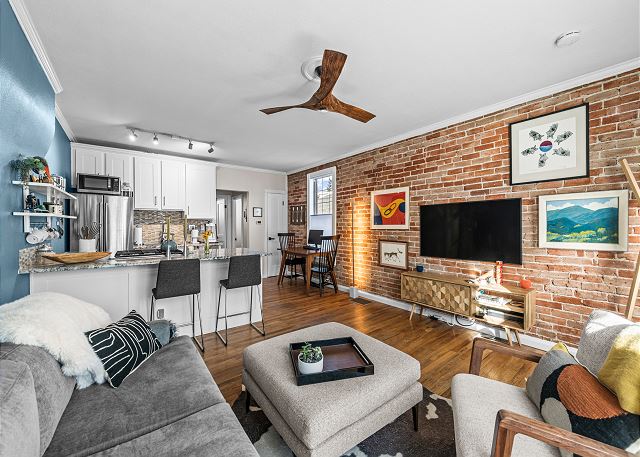 Open Concept Entry, Living Room, Kitchen, and Dining Space - Beautiful Exposed Brick Wall 