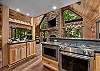 Gorgeous chef's Kitchen with gas oven/stove, stone counters and coffee station looking into the Great Room.