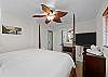 Main Bedroom with Ceiling Fan and TV